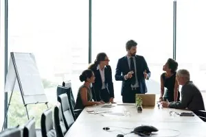 A corporate leadership team collaborates in a boardroom, representing the high-performing FMCG commercial talent agribusiness brands need to attract.