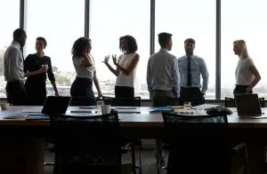 Executive business leaders and corporate stakeholders discussing workforce strategies and succession planning in a modern boardroom.